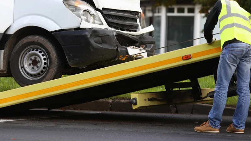 Scrap car being collected in Birmingham by a licensed removal service